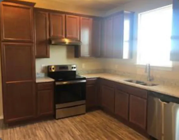 a kitchen with a sink and a refrigerator