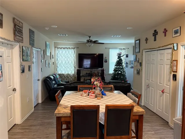 a dining room with furniture and a chandelier
