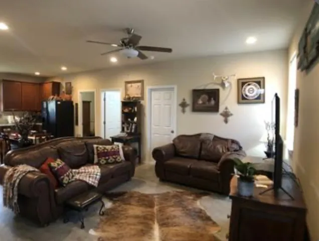 a living room with furniture and a mirror