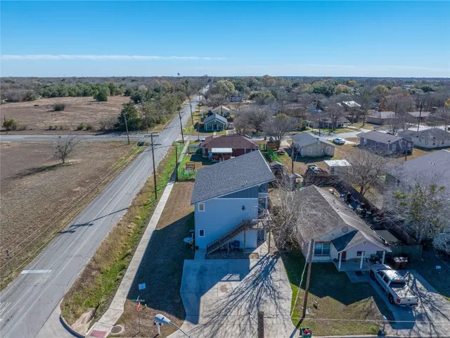 an aerial view of a house with a yard