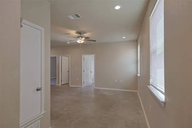 a view of an empty room with a fan