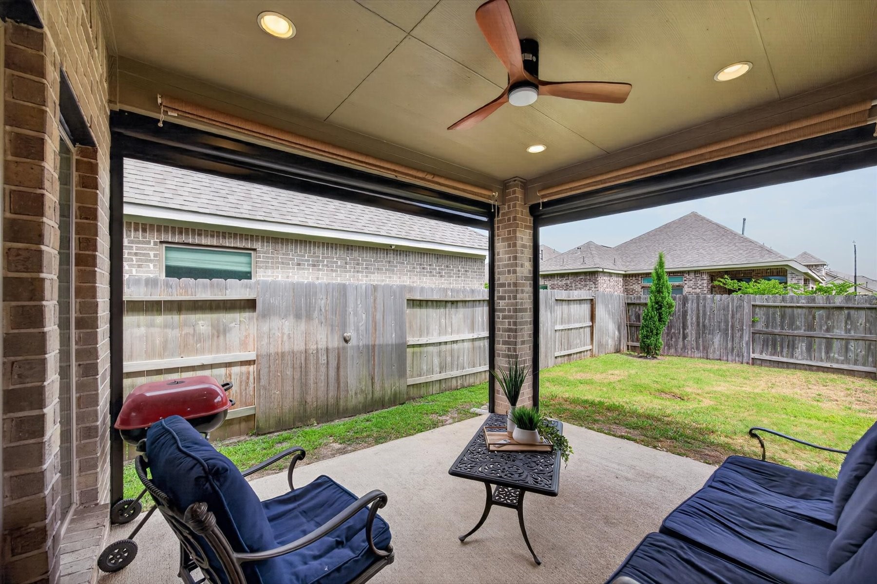 23026 Needle Grass Road Katy, TX 77493 - Photo 32 of 33 Relax outdoors all year round with remote controlled screened covered patio with added privacy.