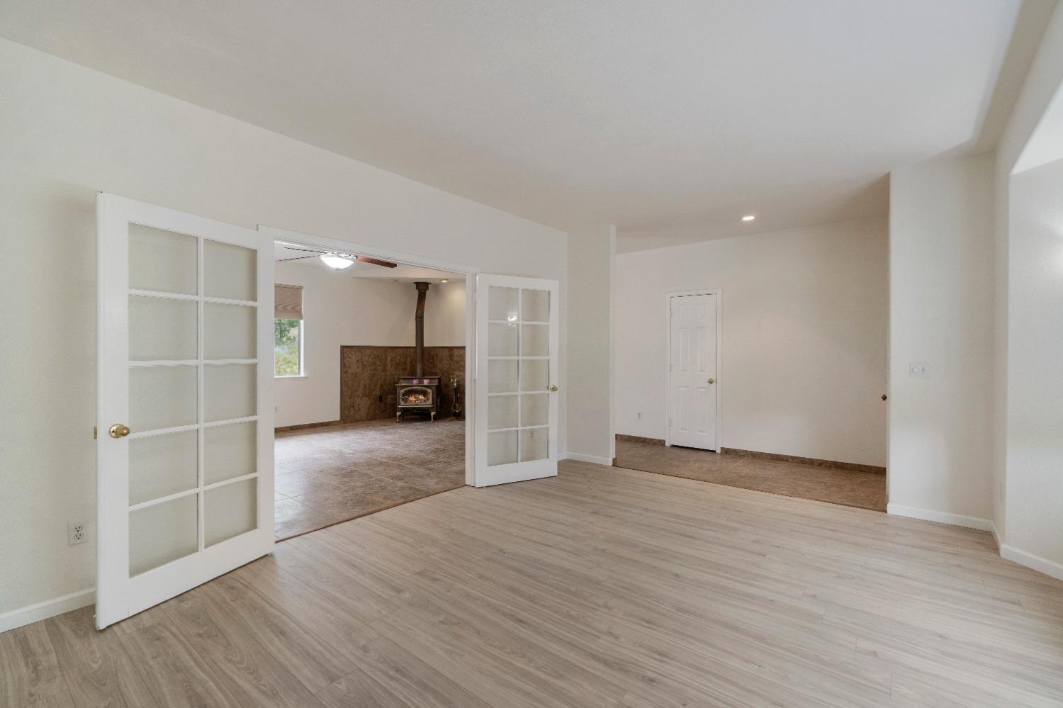 6864 Rodeo Drive Sanger, CA 93657 - Photo 11 of 48 a view of empty room with wooden floor and window