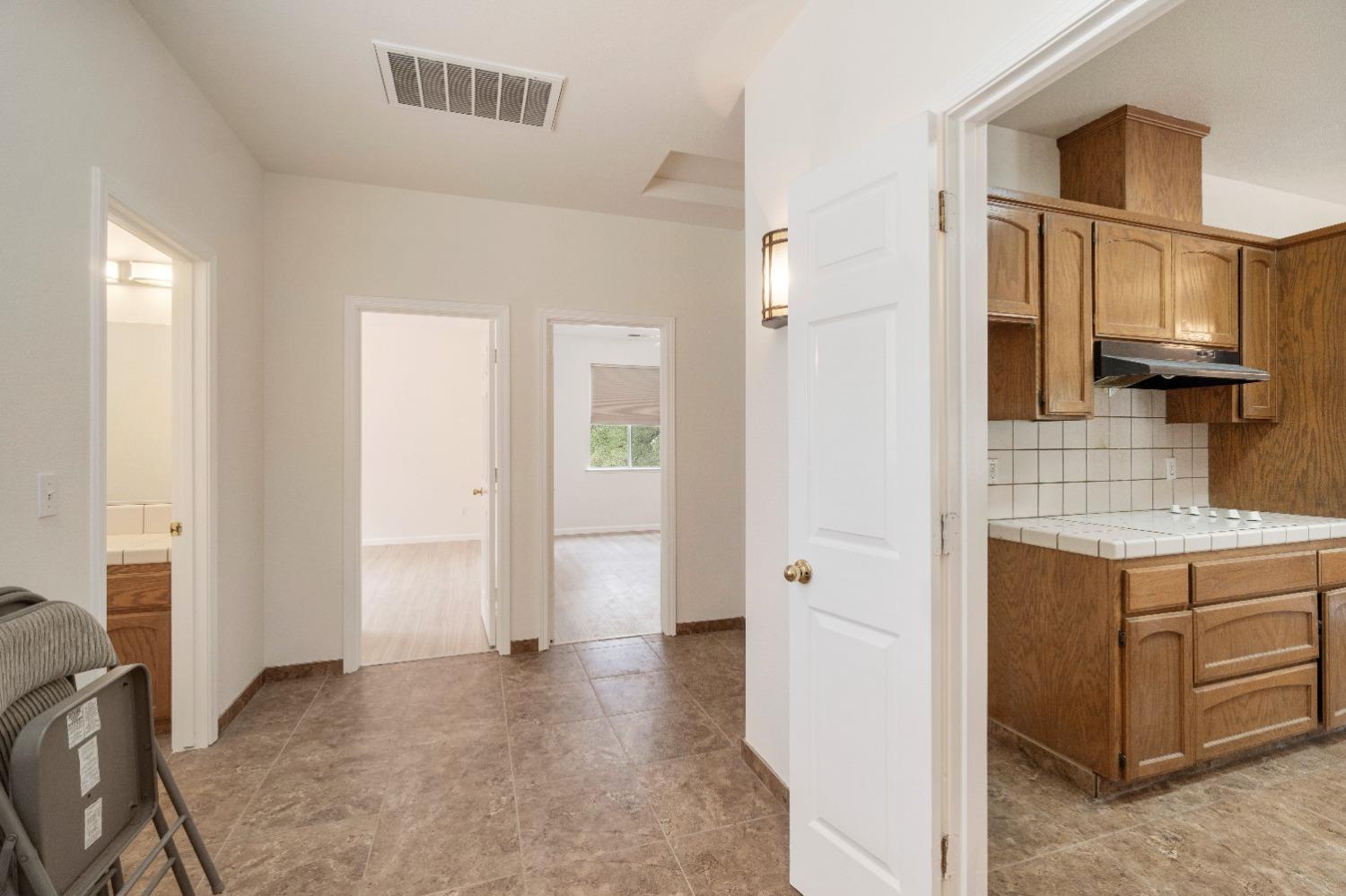 6864 Rodeo Drive Sanger, CA 93657 - Photo 21 of 48 a view of a kitchen with cabinets and wooden floor