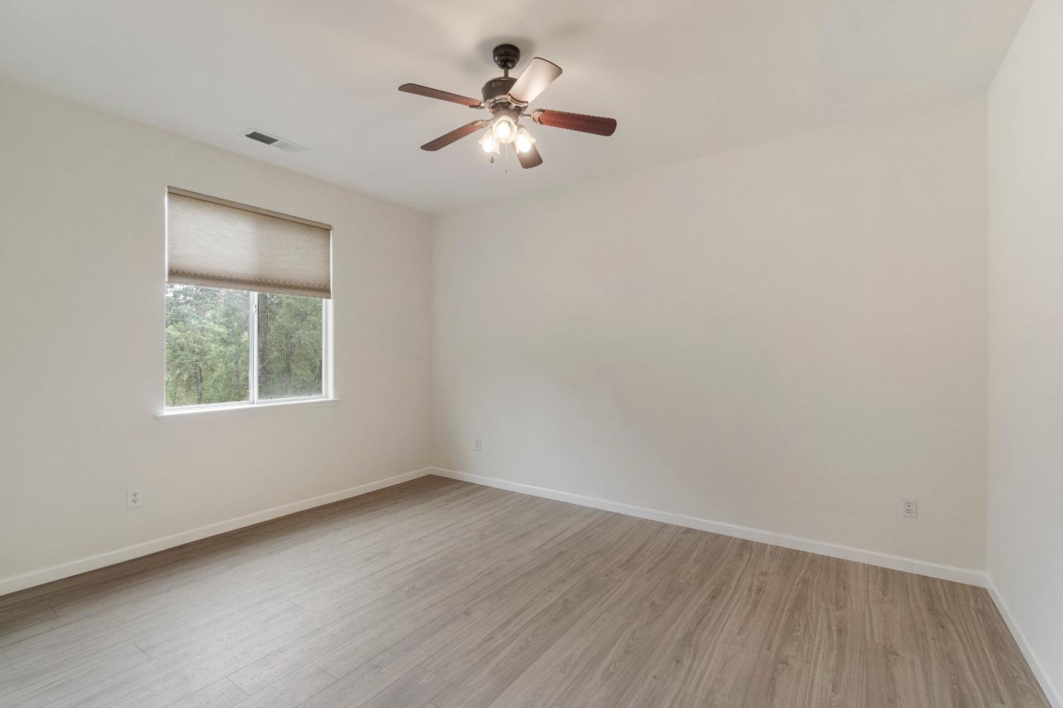 6864 Rodeo Drive Sanger, CA 93657 - Photo 23 of 48 an empty room with a window and a fan