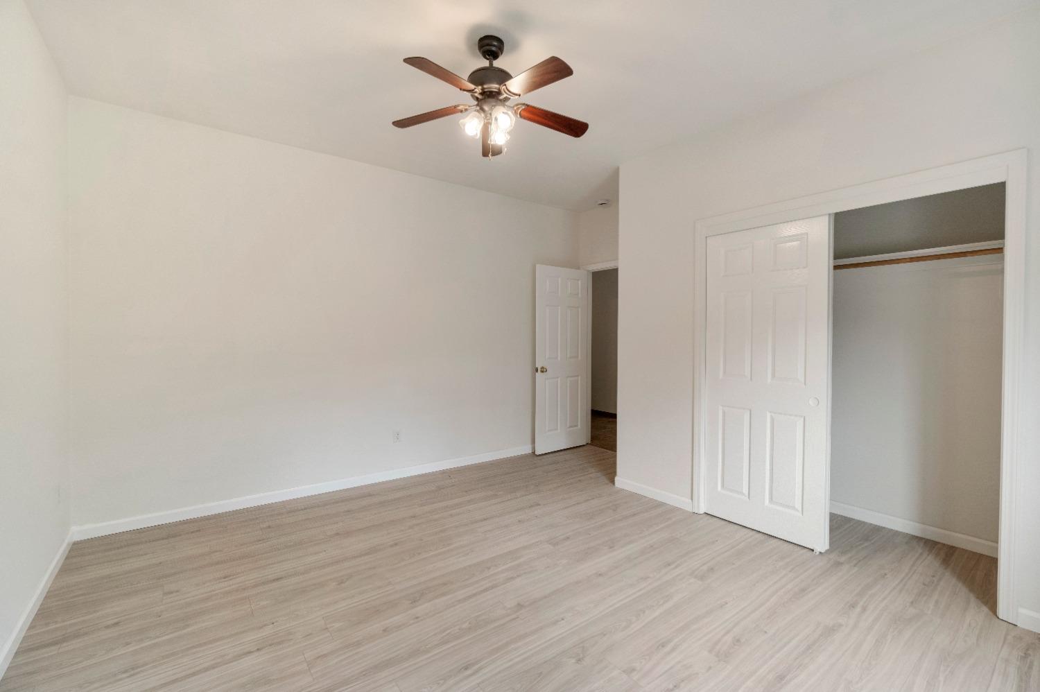 6864 Rodeo Drive Sanger, CA 93657 - Photo 24 of 48 a view of an empty room with wooden floor