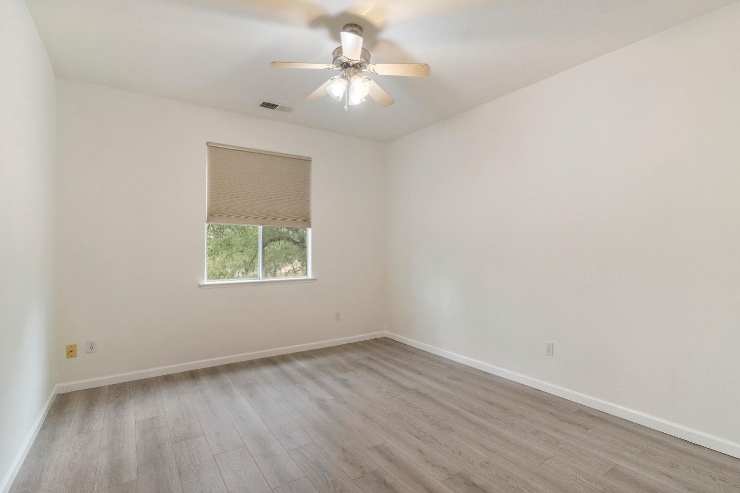 6864 Rodeo Drive Sanger, CA 93657 - Photo 25 of 48 an empty room with a window and a fan