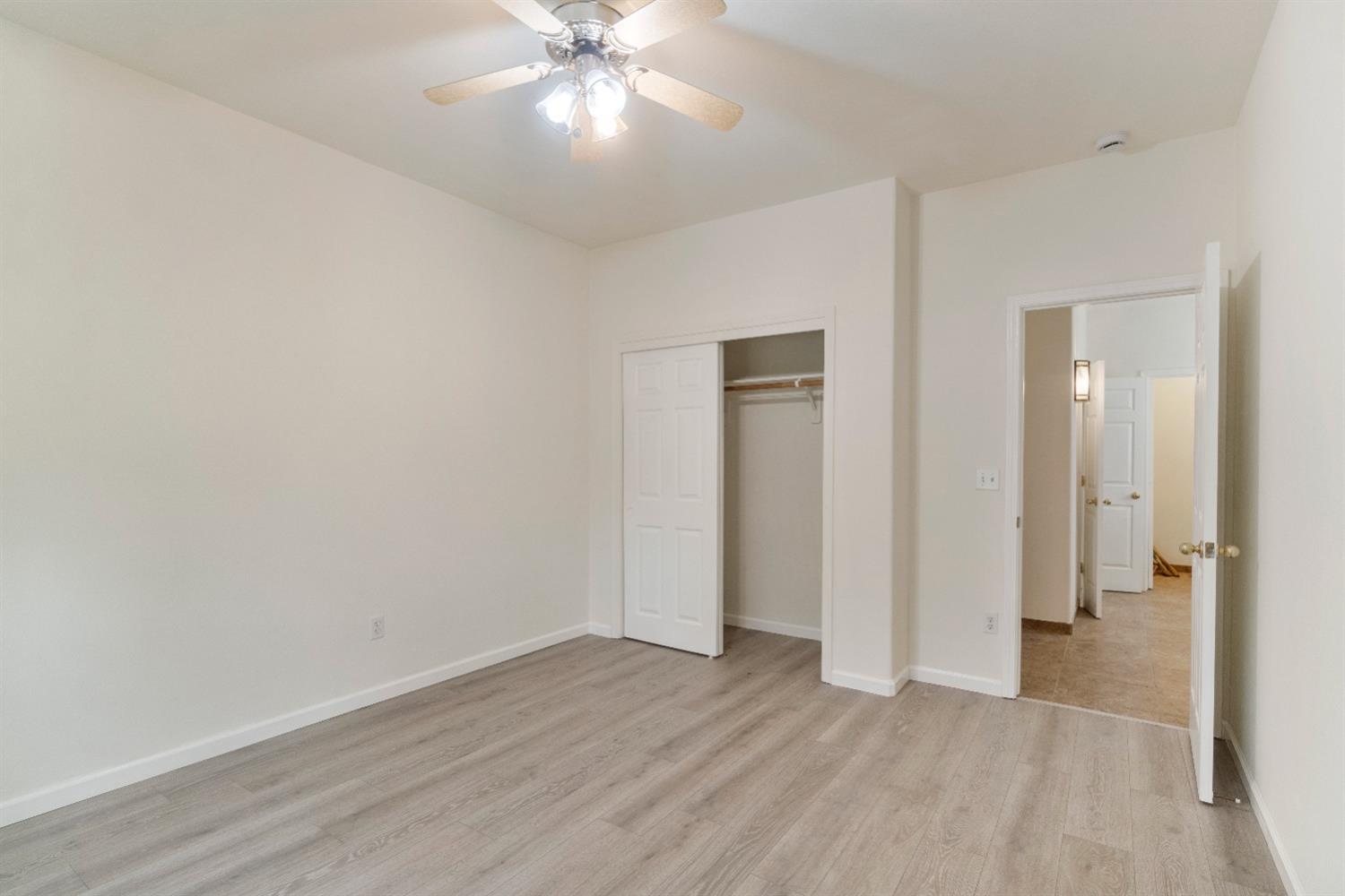 6864 Rodeo Drive Sanger, CA 93657 - Photo 26 of 48 an empty room with wooden floor and closet area
