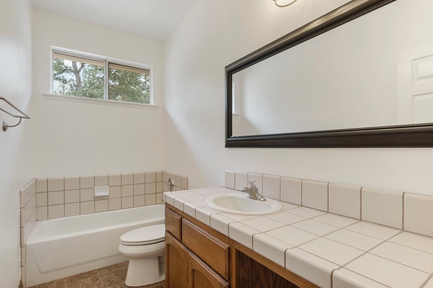 6864 Rodeo Drive Sanger, CA 93657 - Photo 27 of 48 a bathroom with a sink a toilet and bathtub