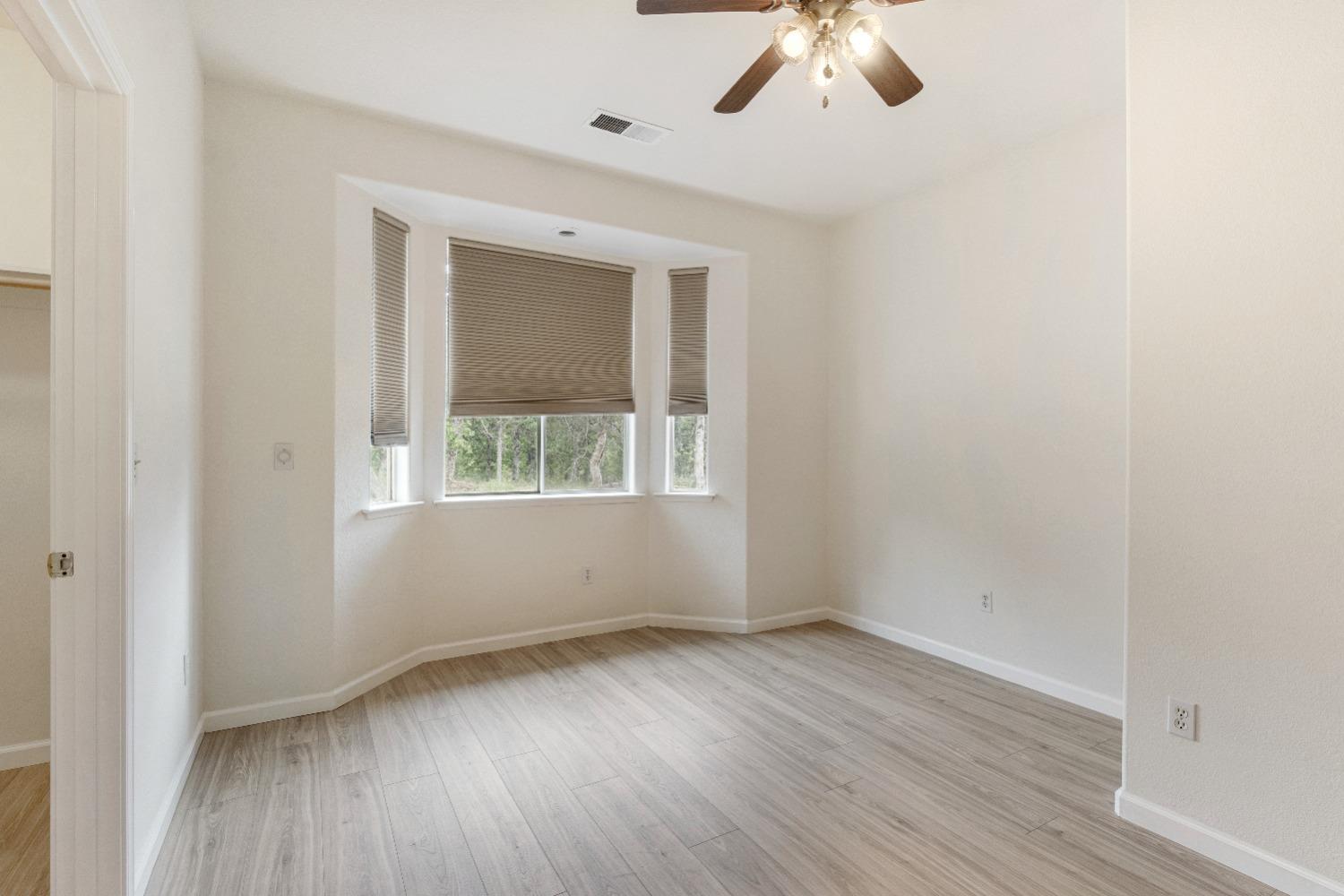 6864 Rodeo Drive Sanger, CA 93657 - Photo 28 of 48 an empty room with a window and a ceiling fan