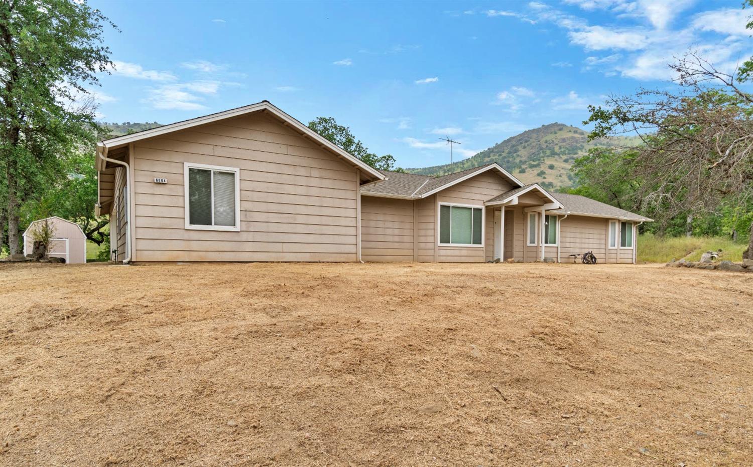 6864 Rodeo Drive Sanger, CA 93657 - Photo 3 of 48 a view of a house with backyard and garden