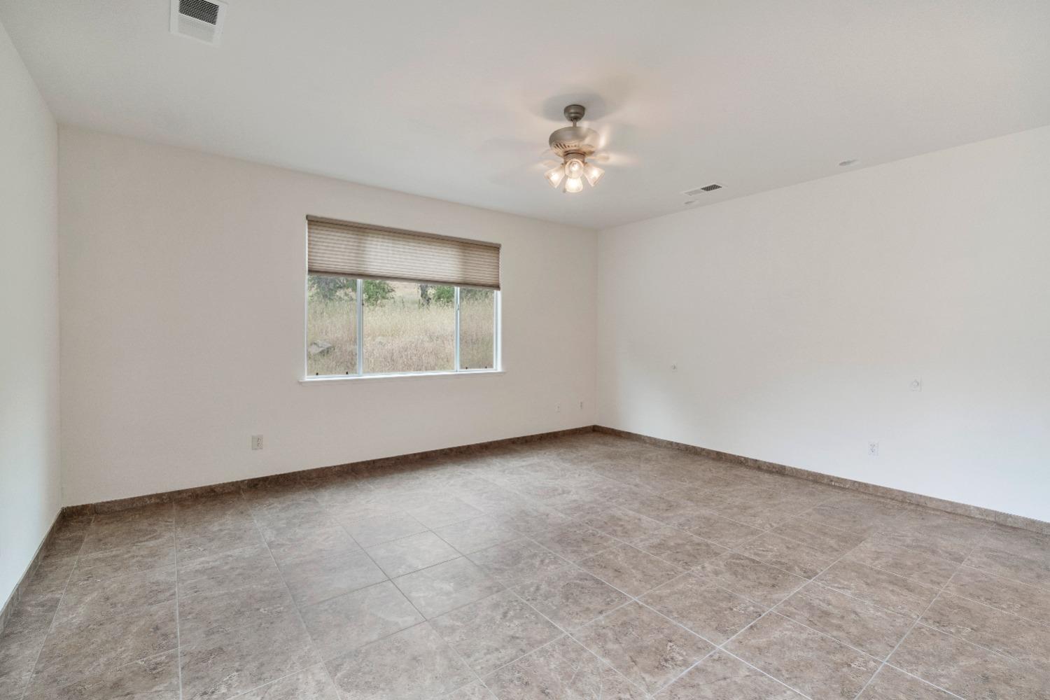 6864 Rodeo Drive Sanger, CA 93657 - Photo 36 of 48 an empty room with a window