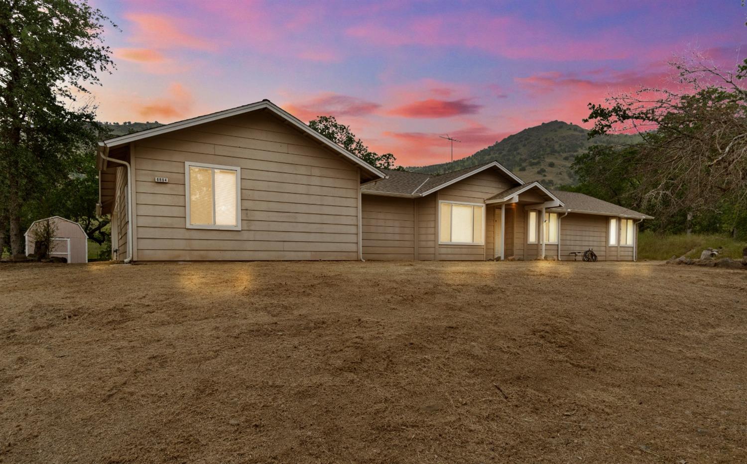 6864 Rodeo Drive Sanger, CA 93657 - Photo 4 of 48 a view of house with backyard space and garden