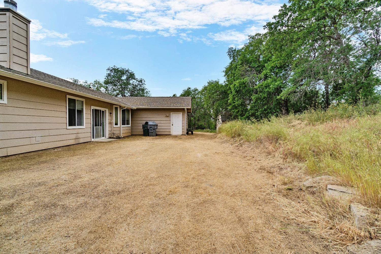 6864 Rodeo Drive Sanger, CA 93657 - Photo 42 of 48 a front view of a house with a yard and trees