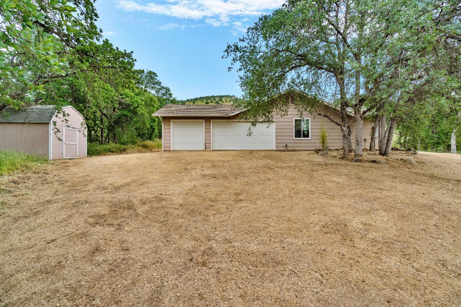 6864 Rodeo Drive Sanger, CA 93657 - Photo 43 of 48 a front view of a house with a yard and garage