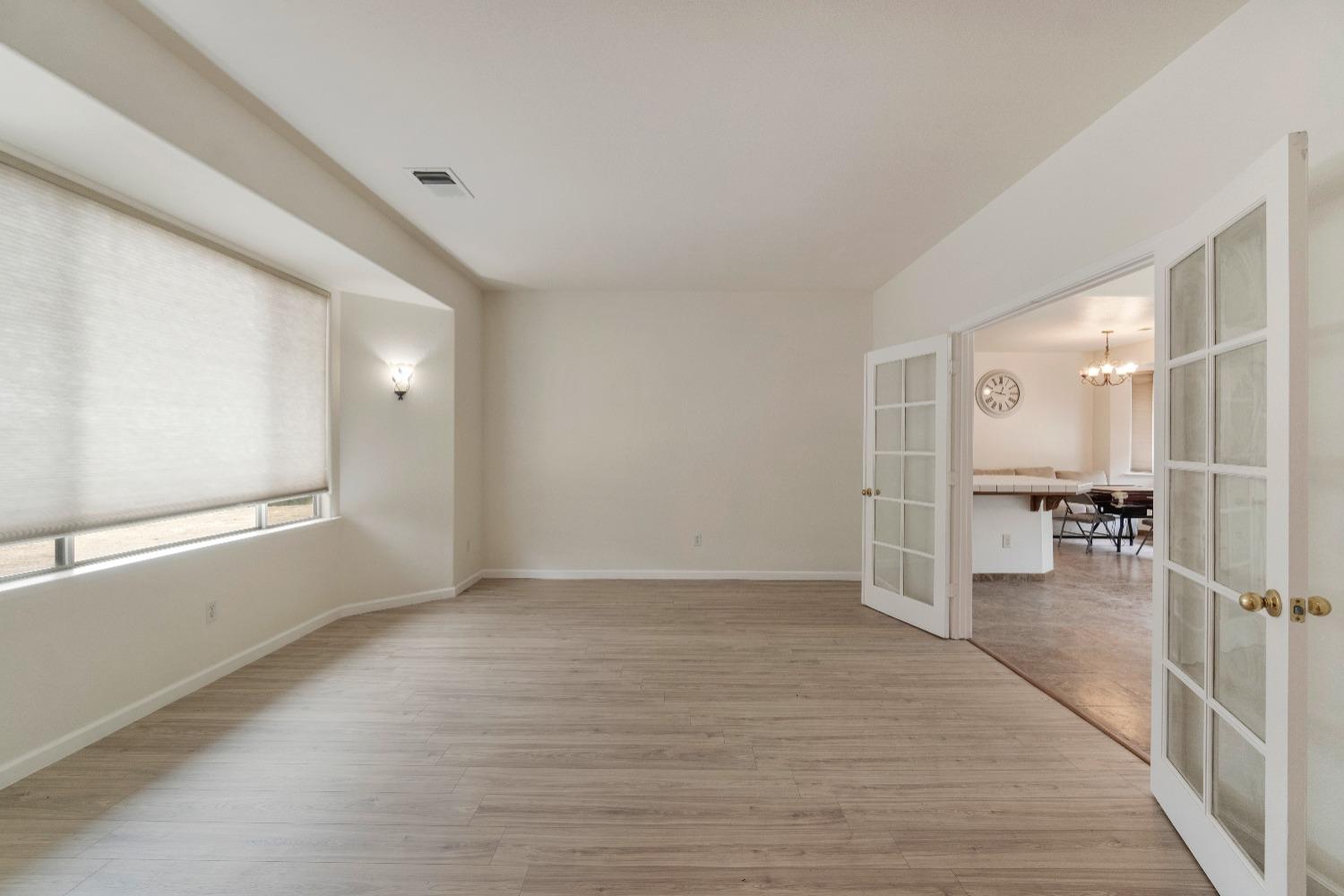 6864 Rodeo Drive Sanger, CA 93657 - Photo 10 of 48 a view of an empty room with wooden floor