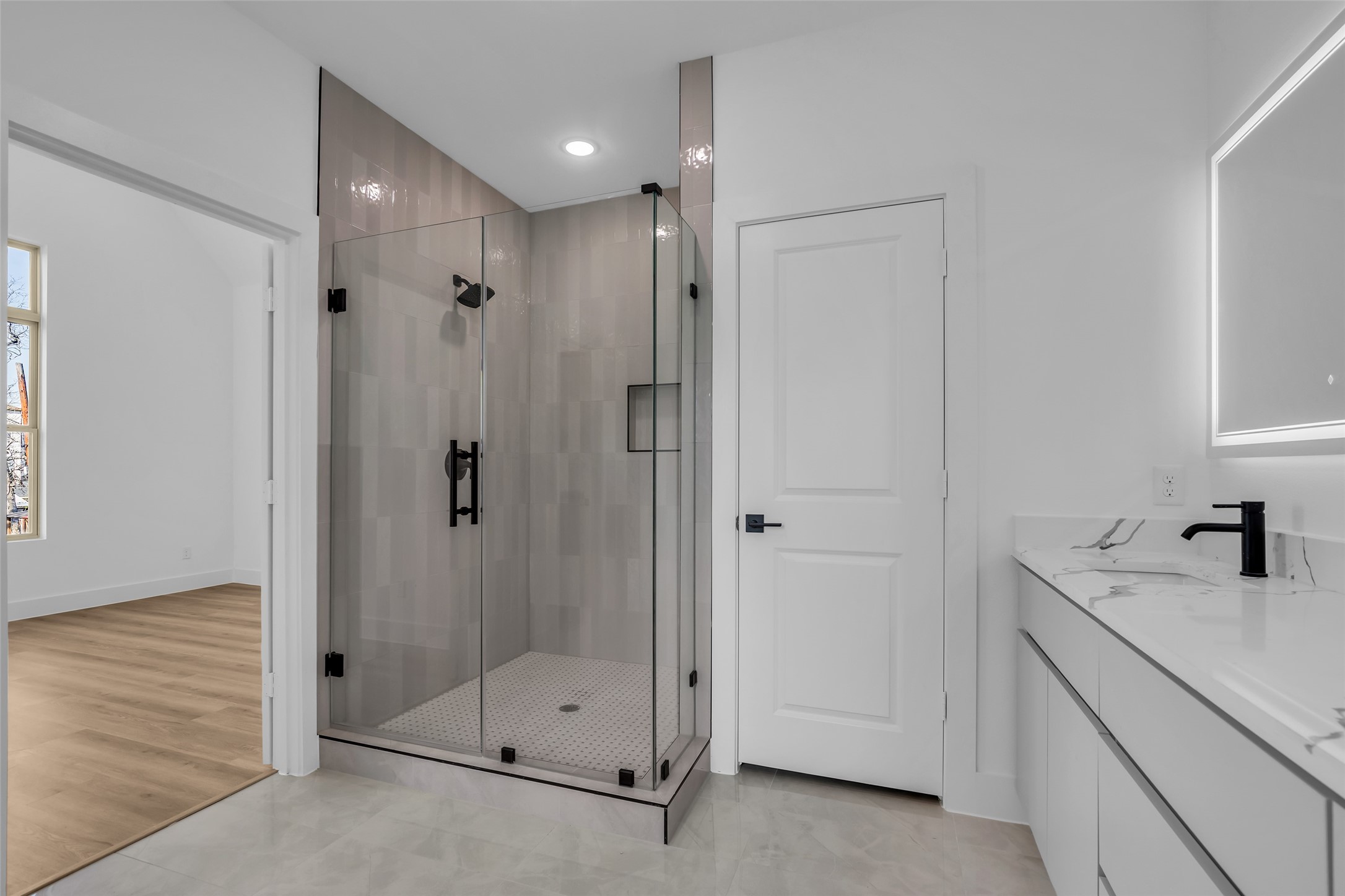 1506 Griffin Street Houston, TX 77009 - Photo 32 of 38 Thoughtfully crafted spa like primary bath, large walk-in shower with beautiful tile walls and flooring, frameless glass surround, marble flooring, dual quartz vanity, and custom soft close cabinetry.