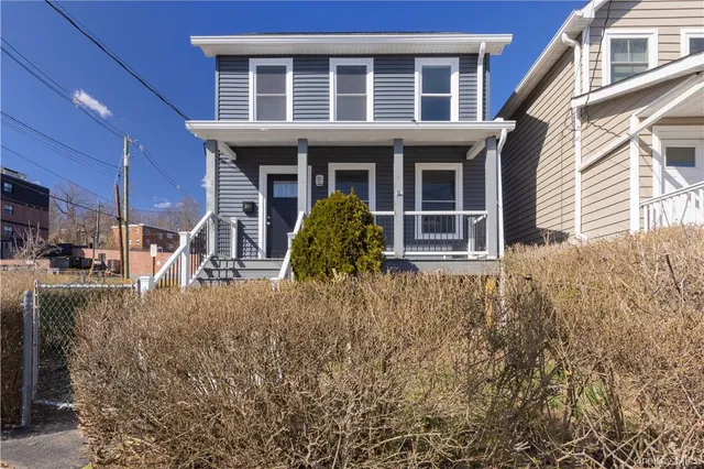 a view of a house with a window and pathway