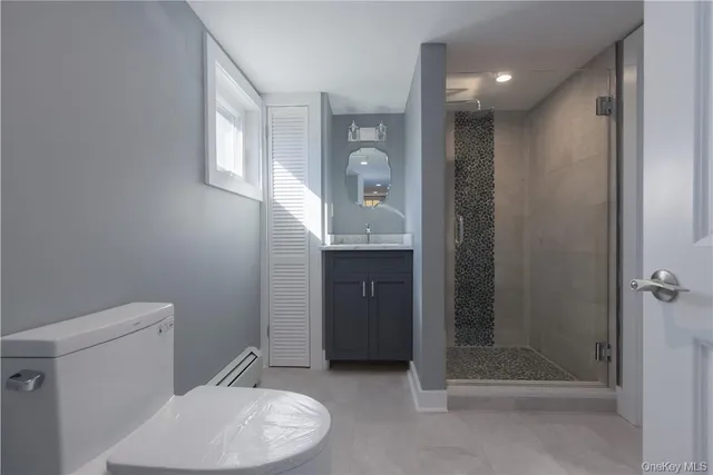 a bathroom with a toilet a sink and shower