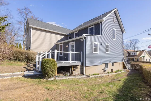 a view of a house with wooden floor and a yard
