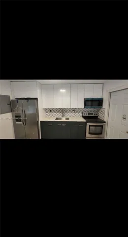 a kitchen with stainless steel appliances a sink and cabinets