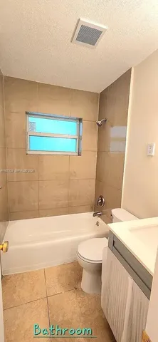 a bathroom with a shower a toilet and sink