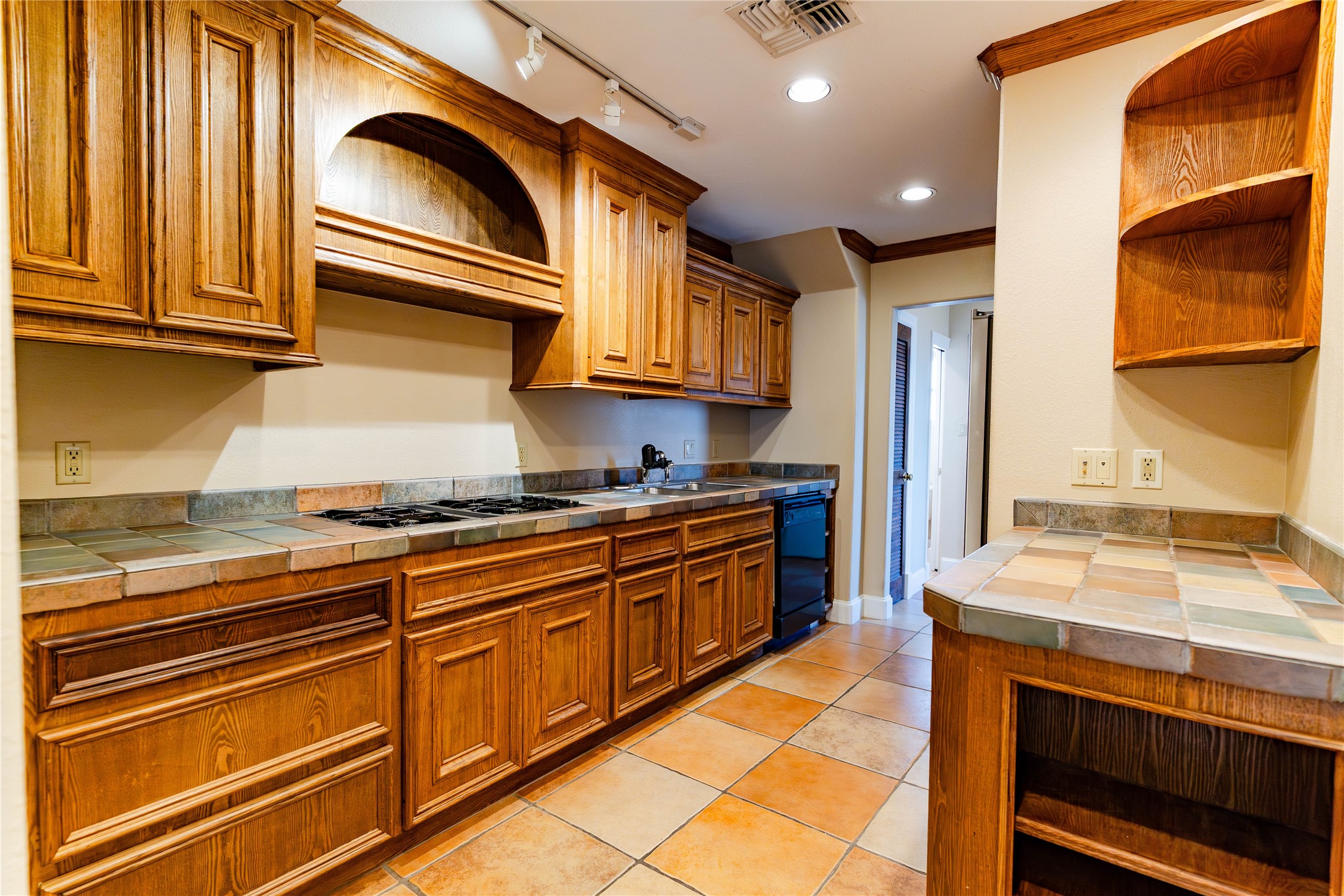 3015 Caroline Street, Unit D Houston, TX 77004 - Photo 5 of 16 a kitchen with stainless steel appliances granite countertop a stove and a sink