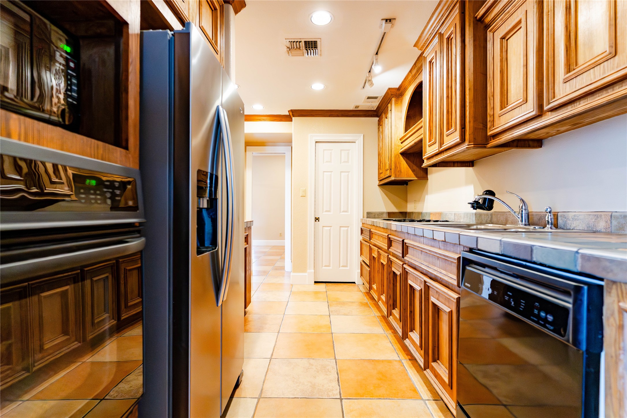 3015 Caroline Street, Unit D Houston, TX 77004 - Photo 6 of 16 a kitchen with stainless steel appliances granite countertop a stove and a refrigerator