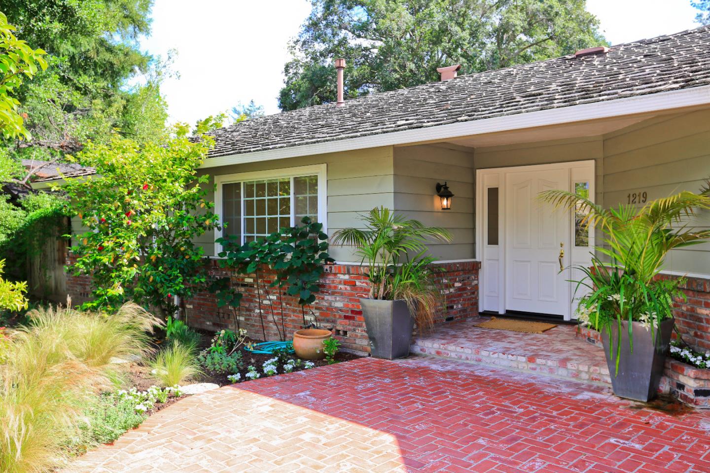 1219 Whitaker Way Menlo Park, CA 94025 - Photo 1 of 19 a front view of a house with a yard