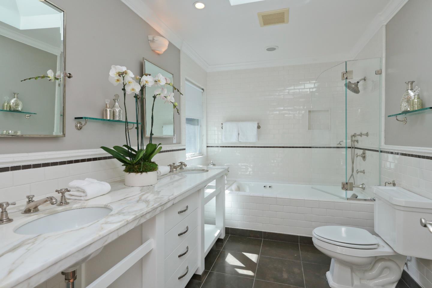 1219 Whitaker Way Menlo Park, CA 94025 - Photo 11 of 19 a bathroom with a granite countertop sink a toilet and mirror