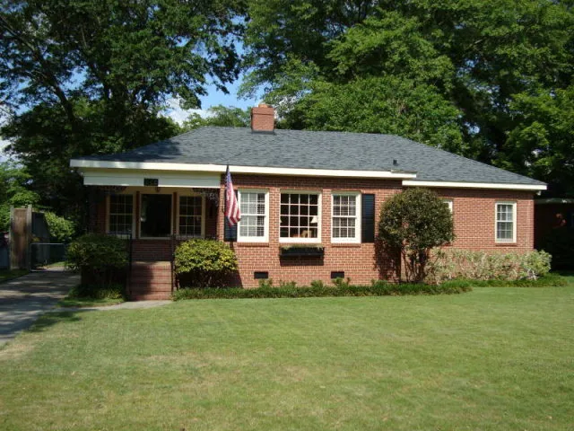 a front view of house with yard and green space