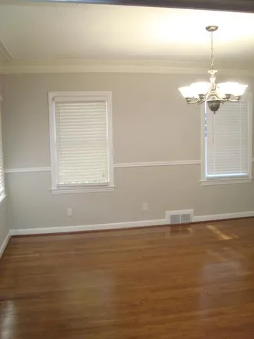 a view of a room with wooden floors