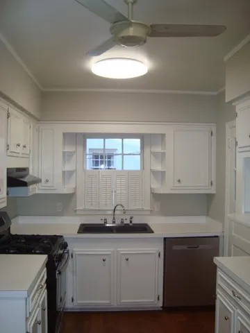 a kitchen with granite countertop a sink stainless steel appliances and cabinets