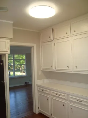 a view of a kitchen cabinets and a window