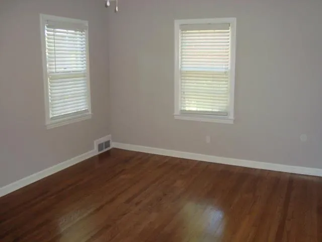 an empty room with wooden closet and a window