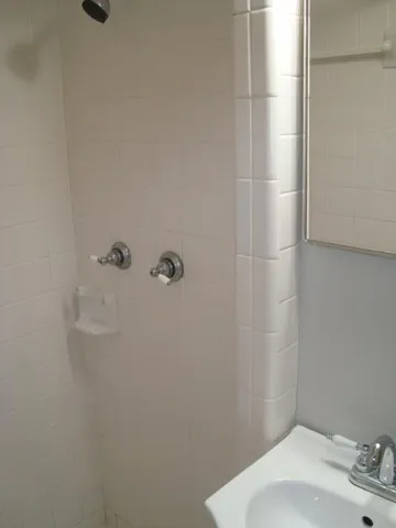 a bathroom with a sink and shower