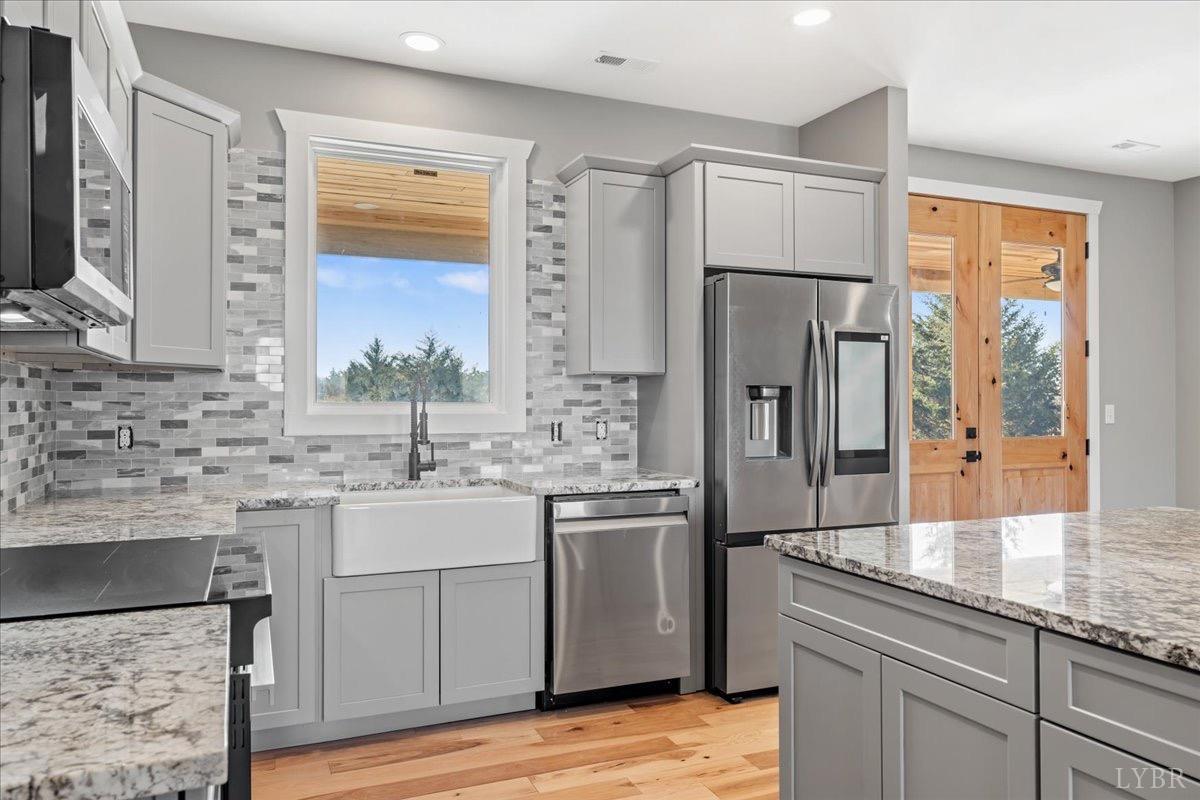 4615 Everett Road Forest, VA 24551 - Photo 17 of 56 a kitchen with kitchen island granite countertop a sink stove and refrigerator