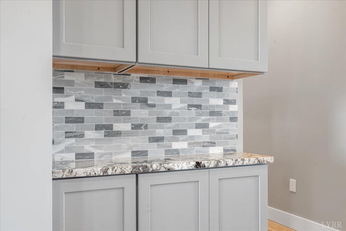 4615 Everett Road Forest, VA 24551 - Photo 20 of 56 a kitchen with granite countertop white cabinets and a sink