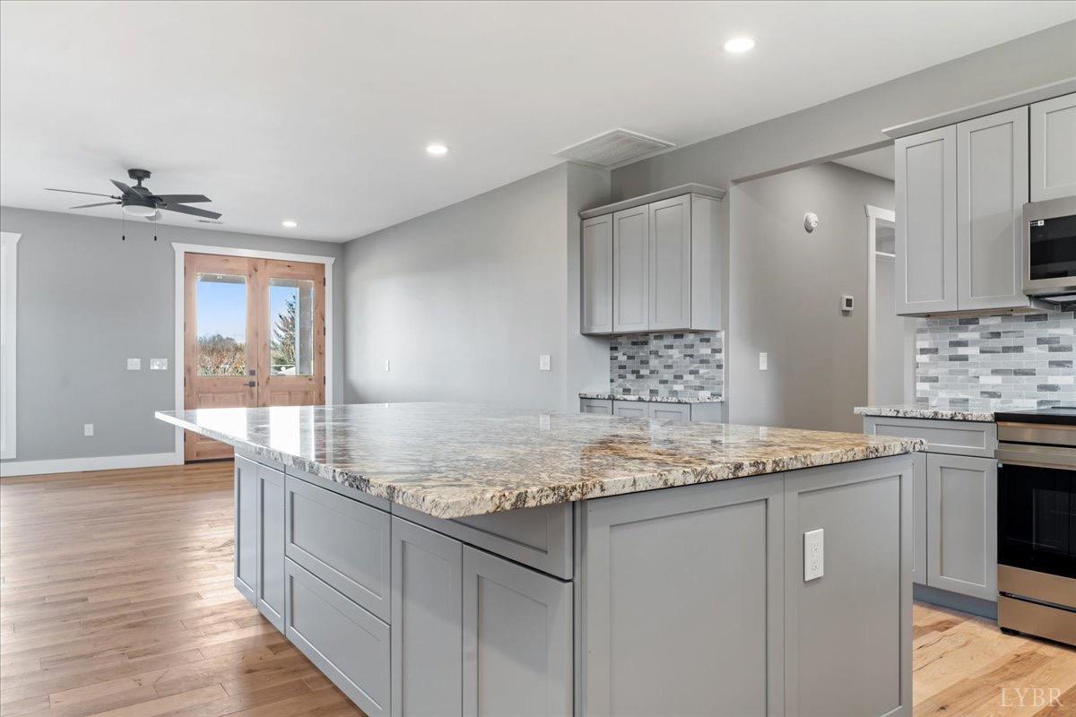 4615 Everett Road Forest, VA 24551 - Photo 21 of 56 a kitchen with stainless steel appliances granite countertop a sink stove and cabinets