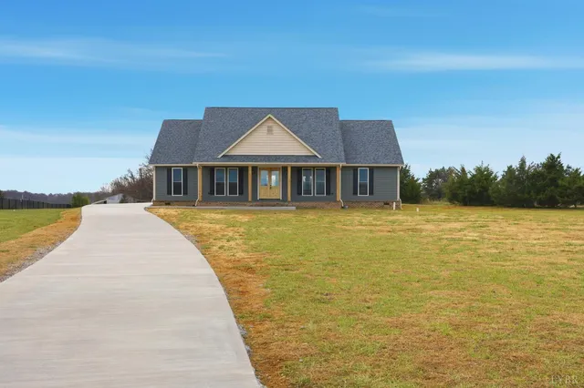 a view of swimming pool with lawn chairs and large trees