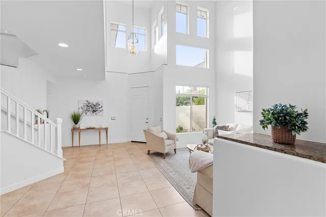 a kitchen with granite countertop white cabinets and stainless steel appliances