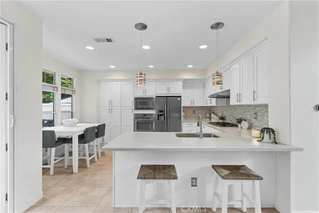 a view of a house with patio and a garden