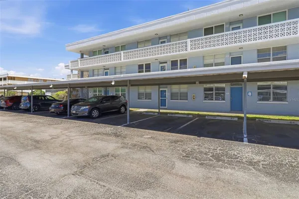 a front view of a building with parking space