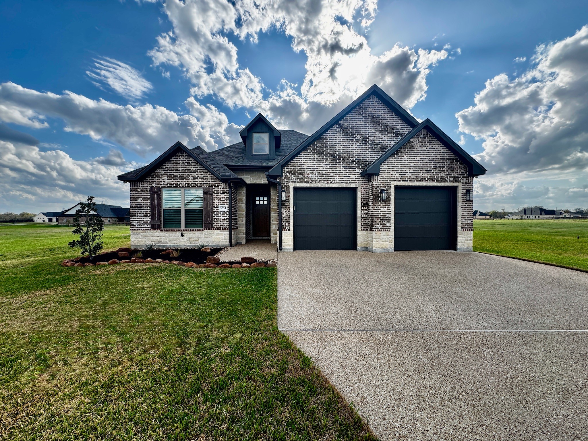 5854 Reliance Ridge Circle Bryan, TX 77808 - Photo 1 of 32 a front view of a house with a garden and yard