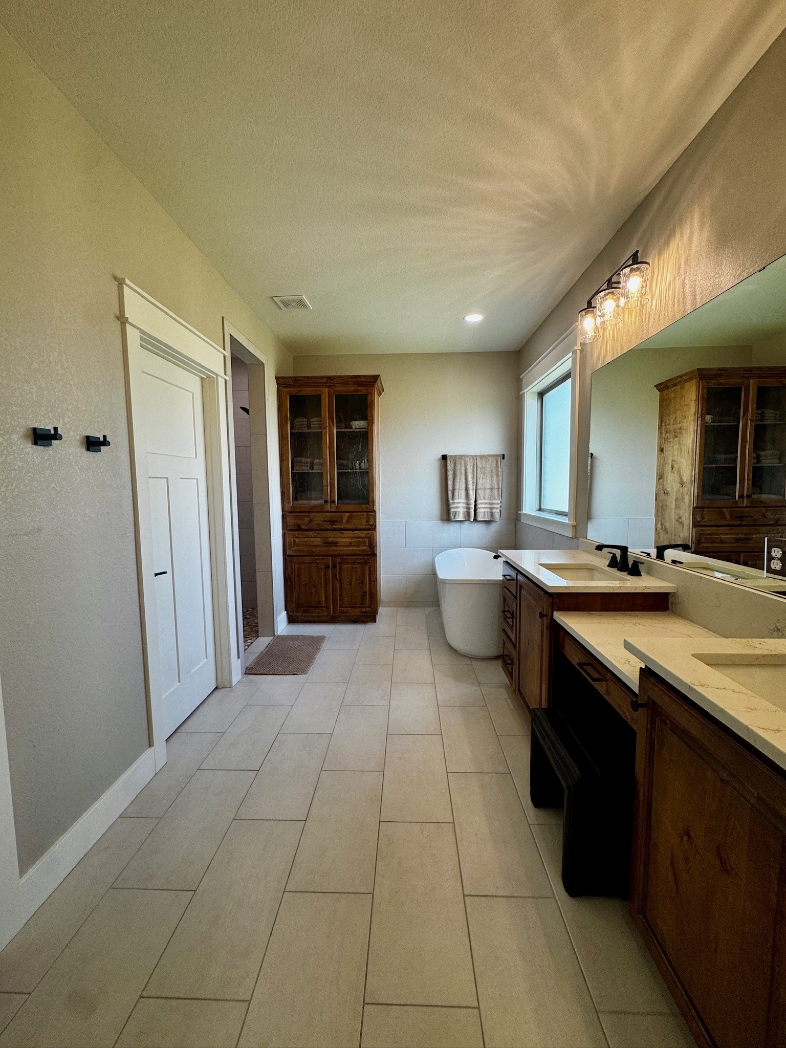 5854 Reliance Ridge Circle Bryan, TX 77808 - Photo 21 of 32 a large bathroom with a sink a large mirror and a shower