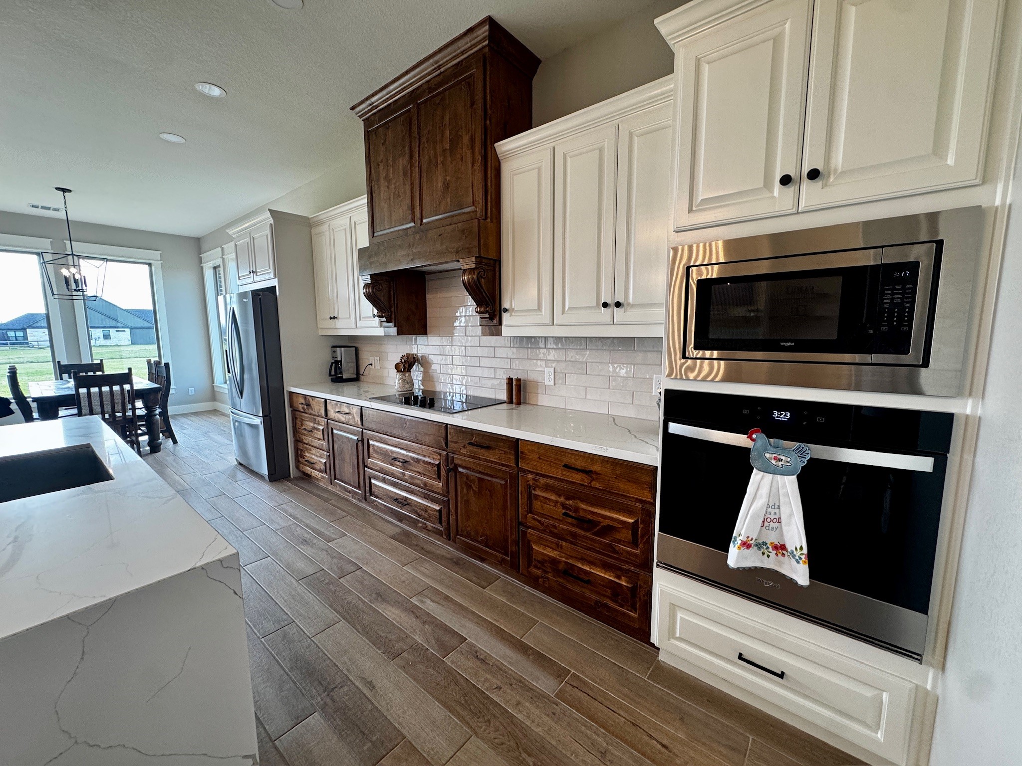5854 Reliance Ridge Circle Bryan, TX 77808 - Photo 4 of 32 a kitchen with stainless steel appliances granite countertop a stove a sink and a microwave