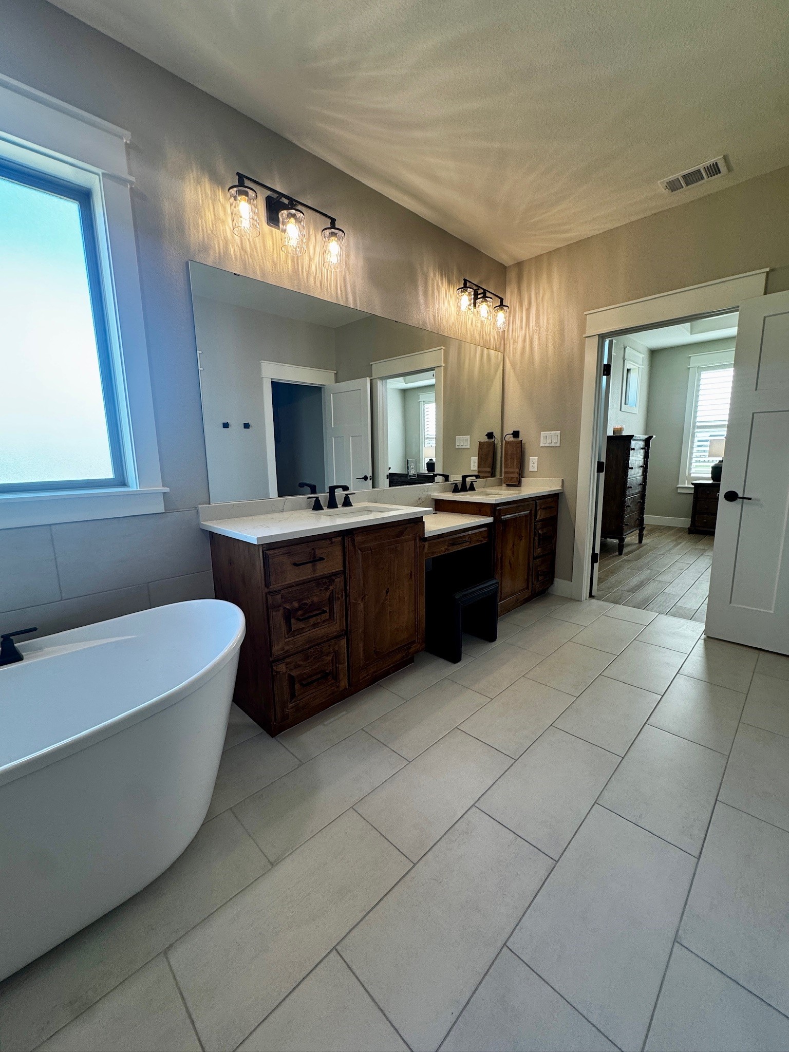 5854 Reliance Ridge Circle Bryan, TX 77808 - Photo 7 of 32 a large bathroom with a large tub and sink