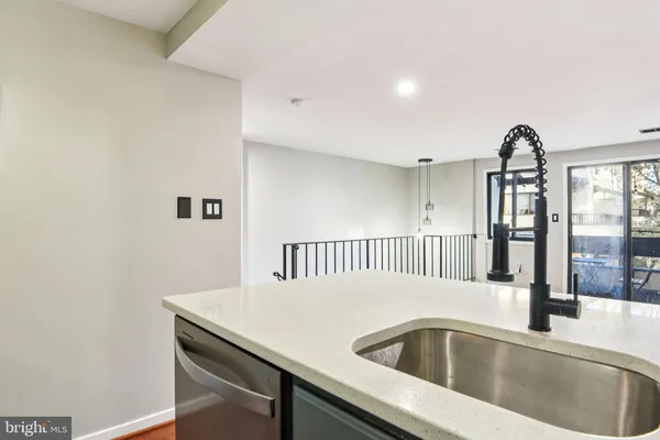 a view of a kitchen counter top a sink and dishwasher