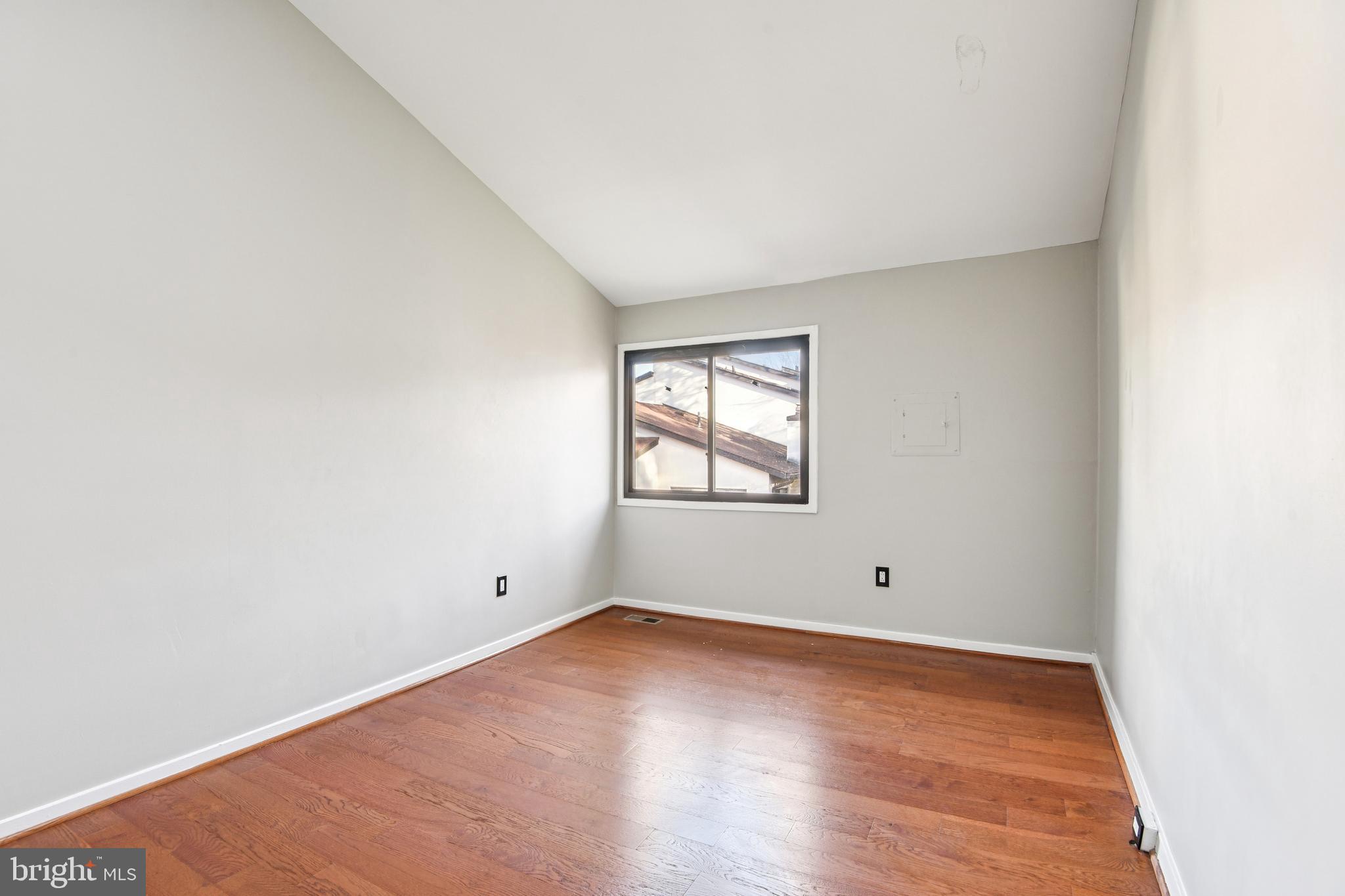 9717 Hellingly Place, Unit 48 Gaithersburg, MD 20886 - Photo 19 of 32 an empty room with wooden floor and windows