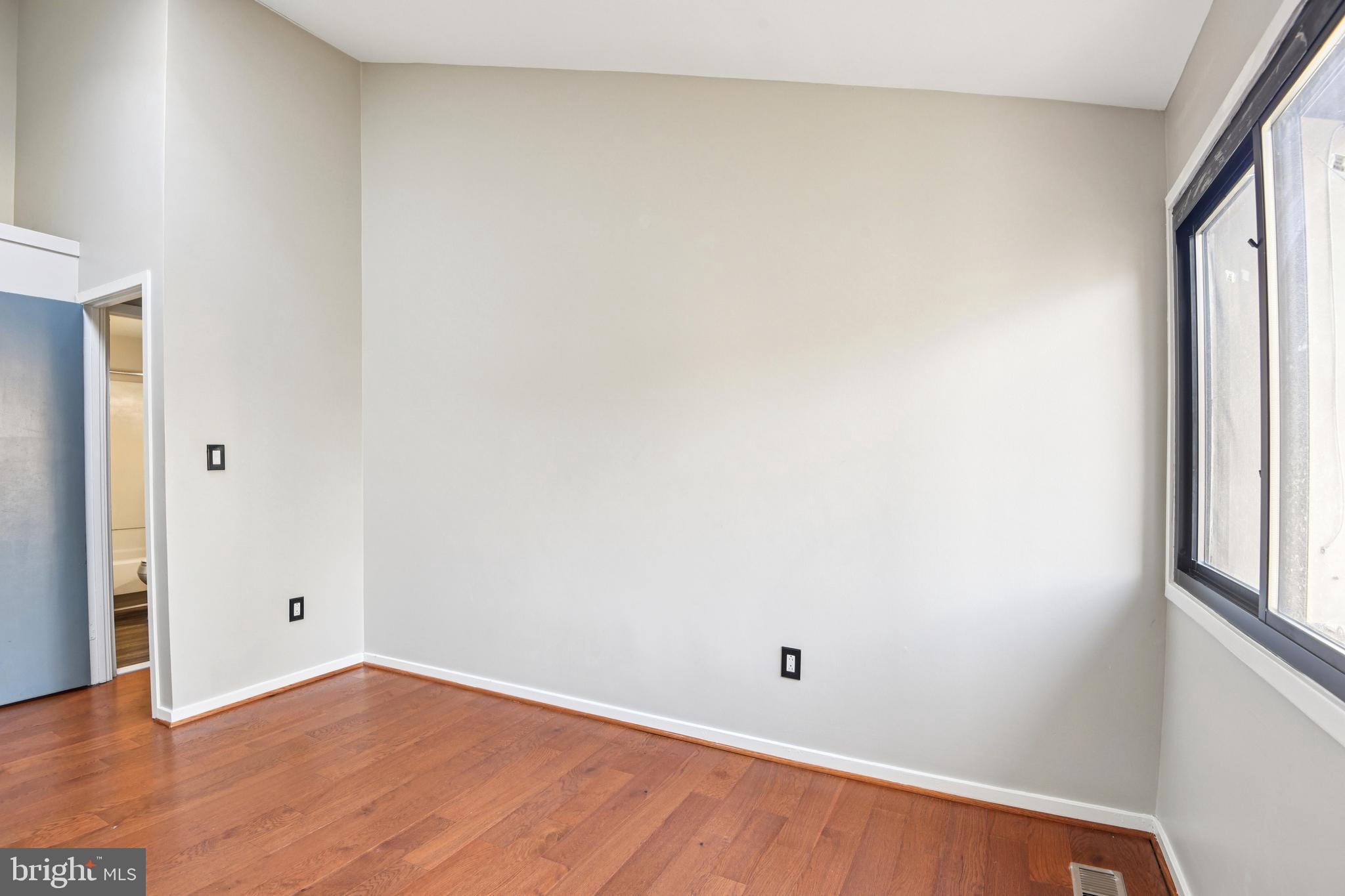 9717 Hellingly Place, Unit 48 Gaithersburg, MD 20886 - Photo 21 of 32 an empty room with wooden floor and windows